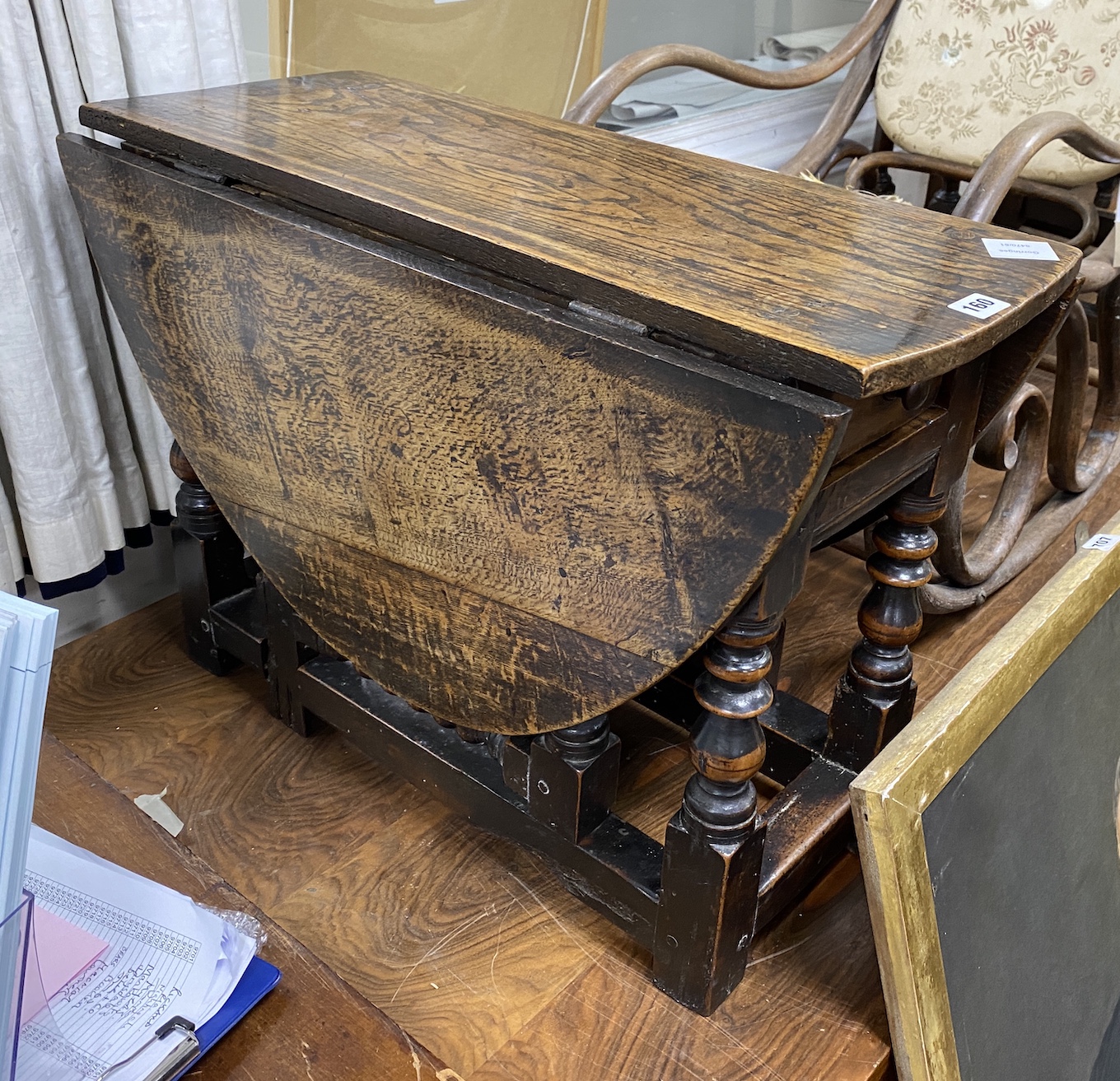 A Charles II low oak and fruitwood oval gateleg table (made-up), with a drawer, square and bobbin turned legs joined by stretchers, width 70cm, depth 30cm, height 49cm